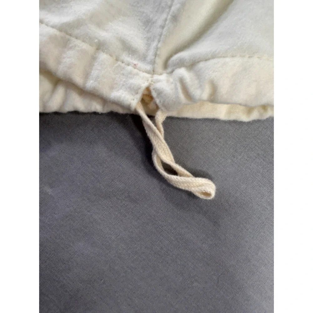 The Frye‎ Company cream-colored cotton dust bag with a drawstring closure boots